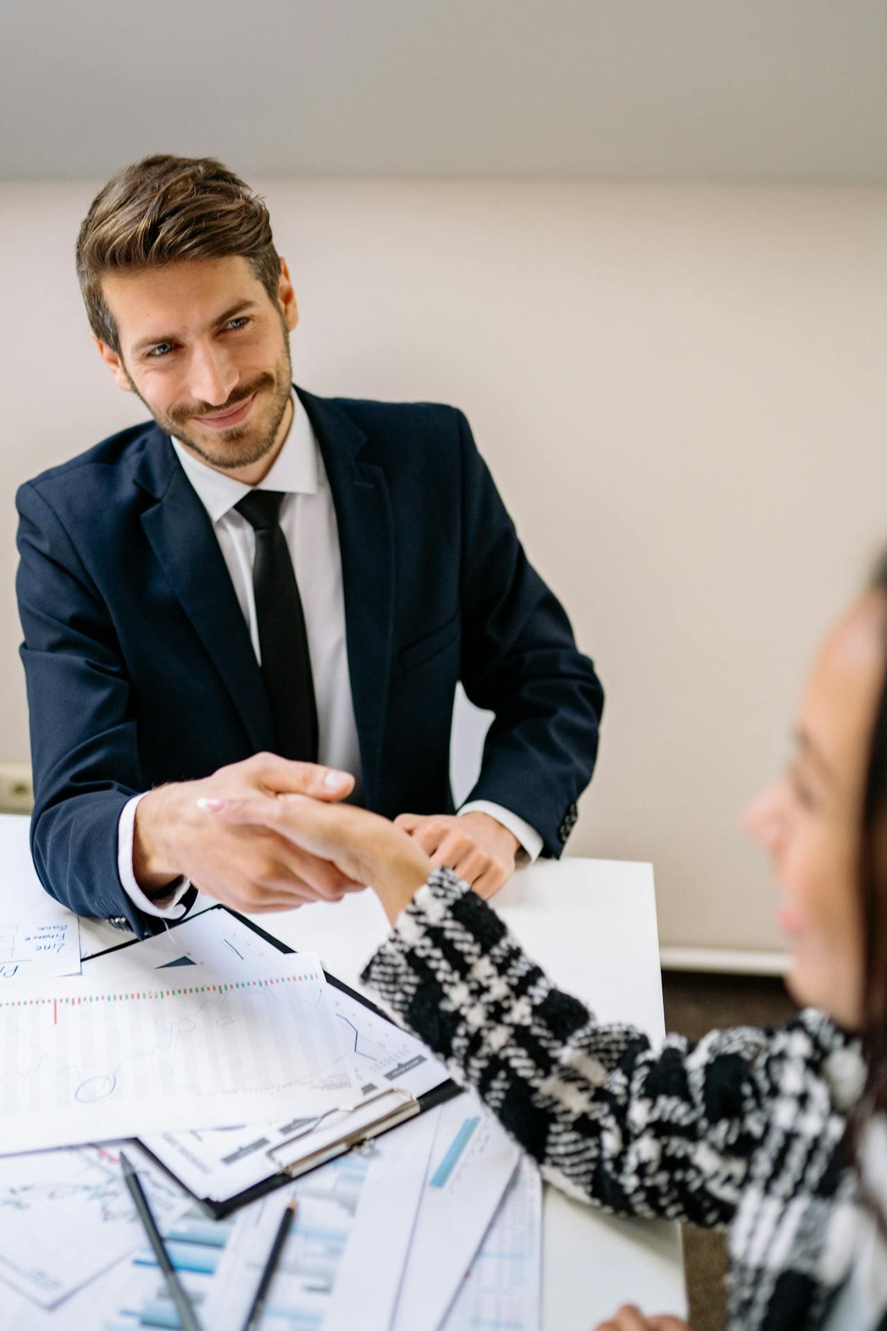 Businessman shaking hands with client for payroll outsourcing services